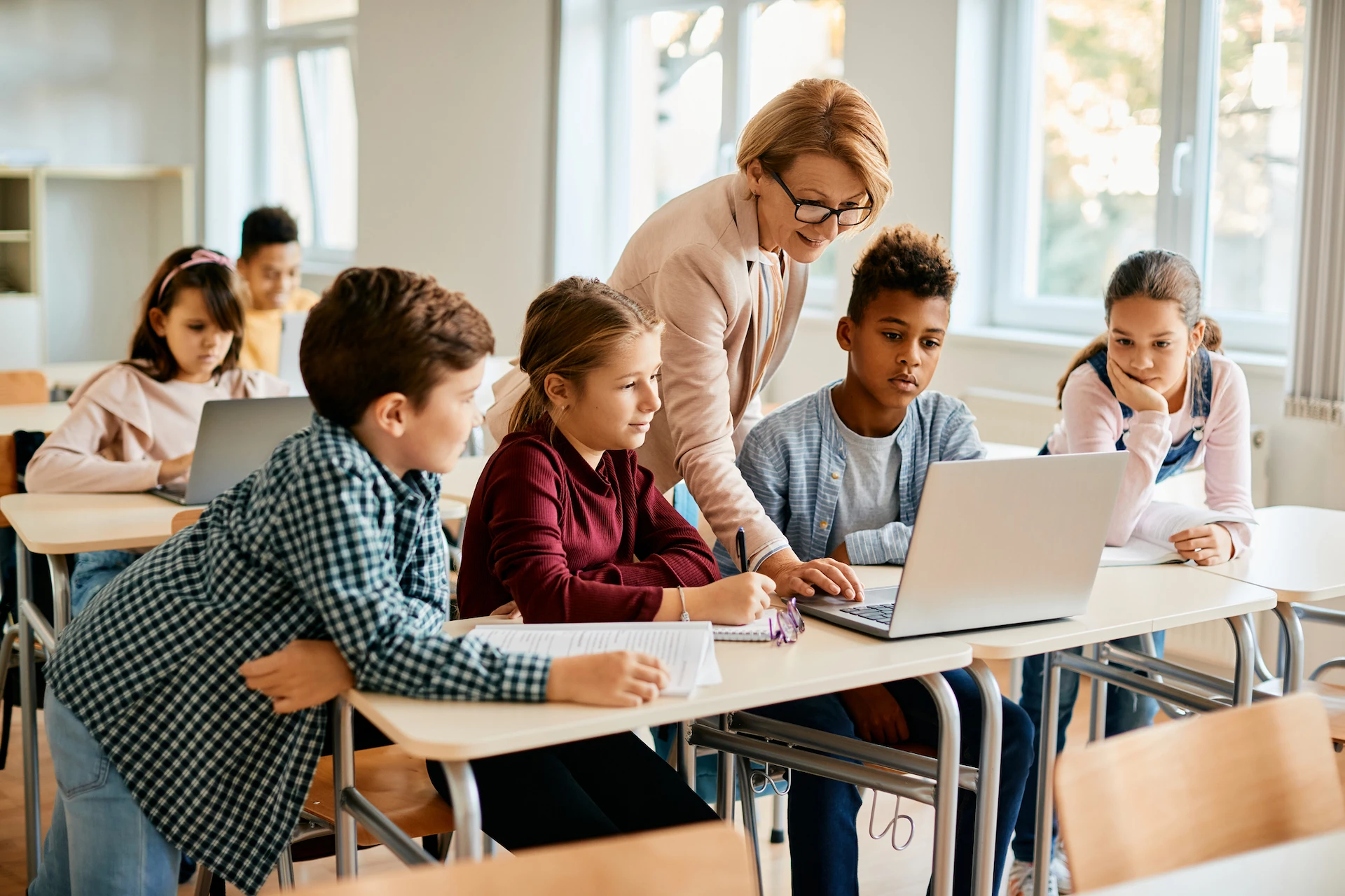 Teacher helping students in classroom