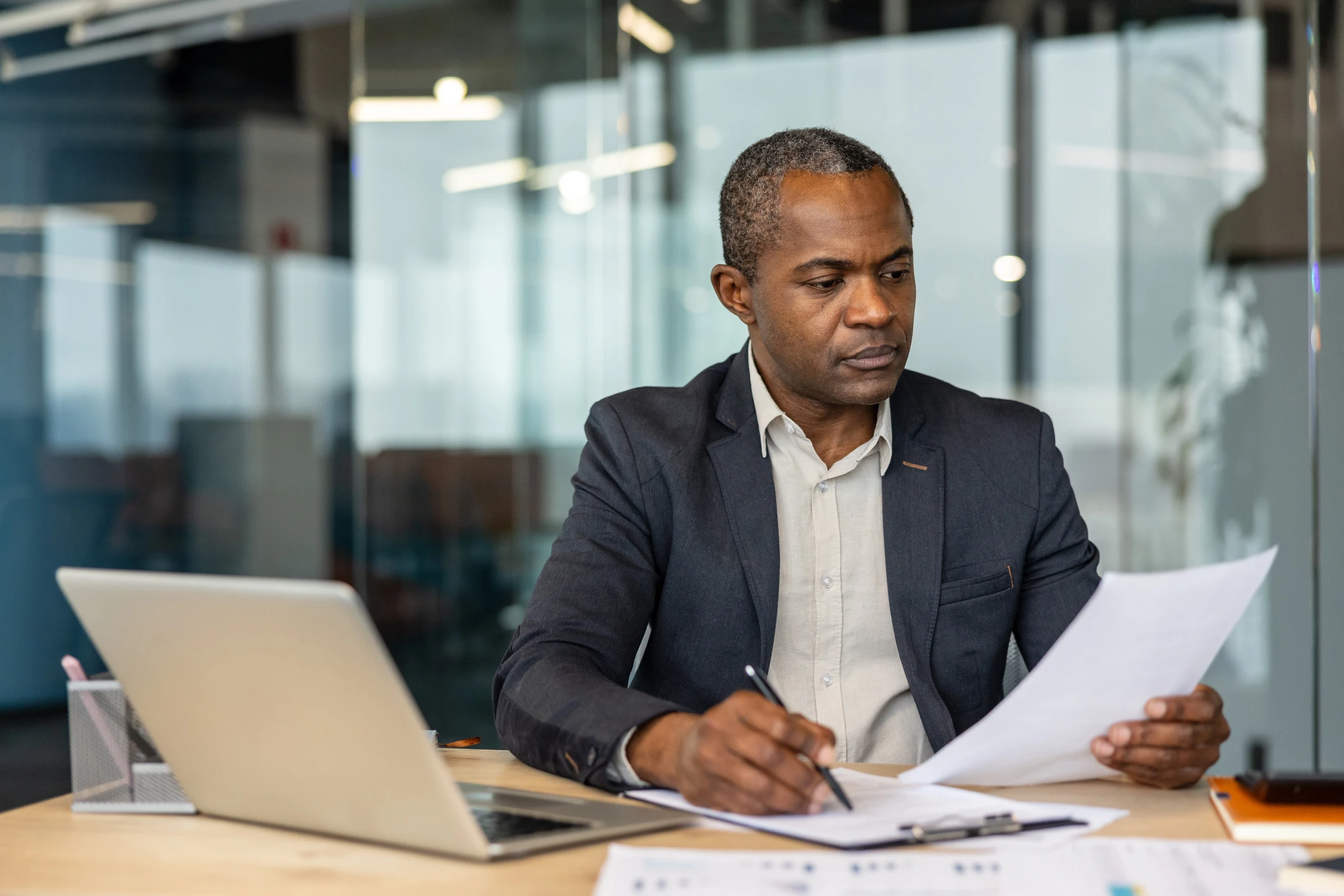 Business man sitting at his desk working on reports