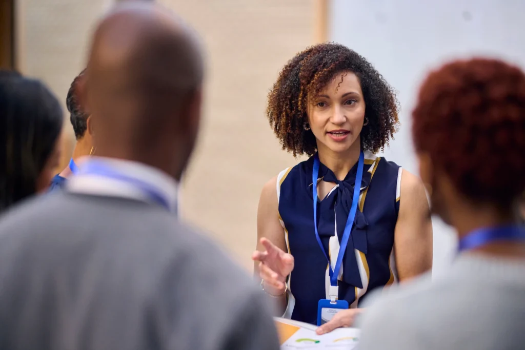 Administrator talking to people at a meeting or conference